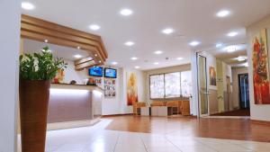 a large room with a lobby with a counter at Central Hotel Löwen in Feldkirch