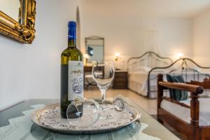 - une bouteille de vin et un verre sur une table dans l'établissement Villa Notos, à Adamas