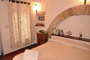 a bedroom with a bed and a large window at Da Marzietta in Assisi