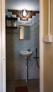 a bathroom with a sink and a mirror at AE Semporna Guesthouse 极潜旅店 in Semporna