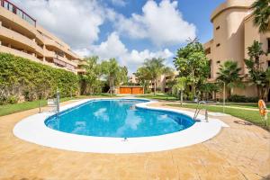 a swimming pool in the middle of a building at Lets in the Sun Blue Cala in La Cala de Mijas