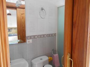 a bathroom with a white toilet and a sink at Casita Canaria in Santa Cruz de Tenerife