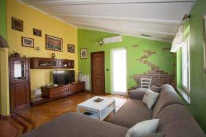 a living room with a couch and a tv at Apartments Tin in Rovinj