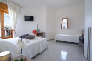 Postel nebo postele na pokoji v ubytování Hotel Residence Costa Azzurra