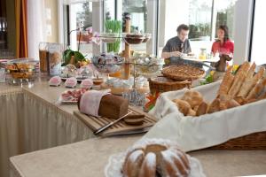 a table with bread and other food on it at Hotel Gasthof Seeland in Sankt Pölten