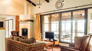 a living room with a couch and a tv at Tahko Golden Resort in Tahkovuori +33 photos