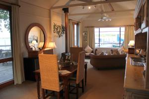 a living room with a table and a dining room at Boathouse - Birks River Retreat in Goolwa