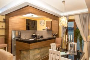 a kitchen with a counter and a dining room at Blanche Cliff Apartments in Sveti Stefan