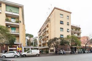 a tall building with cars parked in front of it at Nostalgia Romana in Rome