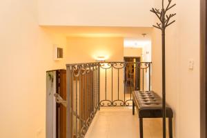 a hallway with a bench and a gate at Blanche Cliff Apartments in Sveti Stefan