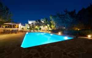 a swimming pool in a backyard at night at Arenal d´Or in Es Figueral Beach