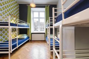 a room with two bunk beds and a window at Atlantis Hostel in Krakow