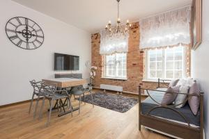 a living room with a table and a dining room at Vip Rotermanni Apartment in Tallinn