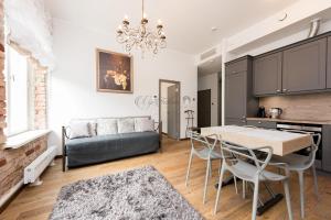 a kitchen and living room with a table and chairs at Vip Rotermanni Apartment in Tallinn