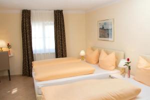 En eller flere senge i et værelse på Hotel Albergo Mamma Rosa