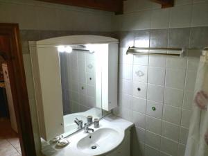 a bathroom with a sink and a mirror at Sirius House in Finikounta