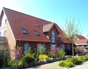 una casa in mattoni con tetto rosso di Ferienwohnungen Hass - Haus 1 a Fehmarn