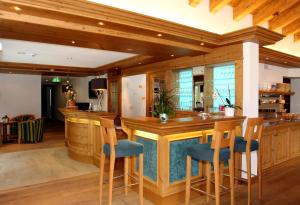a large kitchen with a bar with blue seats at Mountain Paradise in Zermatt