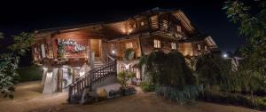 a large wooden house with lights on it at night at Mohrs Herzl Chalet in Werder