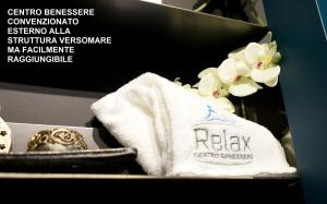 a box with a ring and a towel and a flower at Versomare in Polignano a Mare