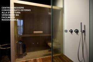 a shower with a glass door in a bathroom at Versomare in Polignano a Mare