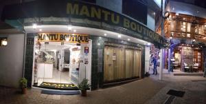 a store front of a man sqor boutique at night at Mantu Boutique in Machu Picchu