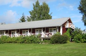 a red house with a gray roof and a yard at Tertin Kartano in Mikkeli +28 photos