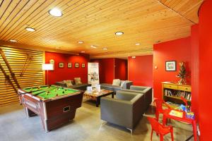 a living room with a pool table and couches at Résidence Néméa Le Nevez in Les Contamines-Montjoie