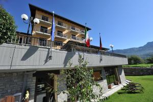 a building with flags on top of it at La Rocca Sport & Benessere in Châtillon