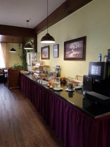a restaurant with a long counter with food on it at Hotel Alte Krone in Tübingen