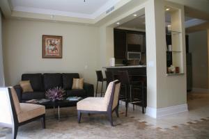 a living room with a couch and a table and chairs at The Atrium Resort in Grace Bay