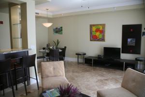 
a living room filled with furniture and a tv at The Atrium Resort in Grace Bay
