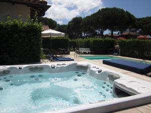 a jacuzzi tub in a yard with a pool at Hotel Villa Smeraldo in Orbetello +50 photos