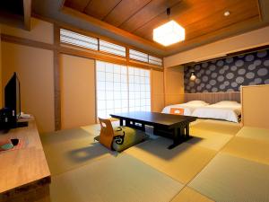 Postel nebo postele na pokoji v ubytování Arai Ryokan