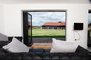 a living room with a couch and a view of a field at The Old Flower Field in Hurstpierpoint