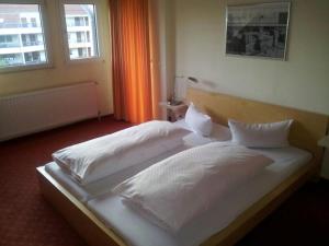 Łóżko lub łóżka w pokoju w obiekcie T&T by Thiesmann