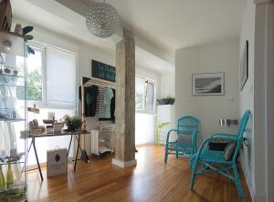 a living room with two blue chairs and a table at Zarautz Hostel in Zarautz