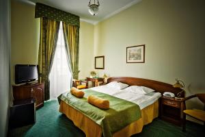 a hotel room with a bed and a television at Shelfort Hotel in Saint Petersburg