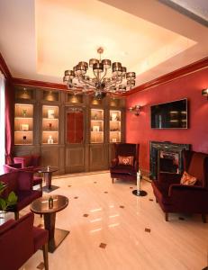 a living room with red walls and a chandelier at Santa Croce Boutique Hotel in Venice