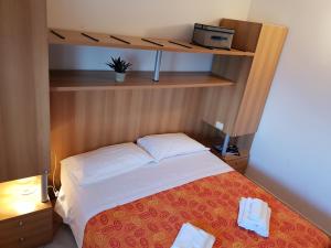 Postel nebo postele na pokoji v ubytování Casa-Albergo Tiroasegno