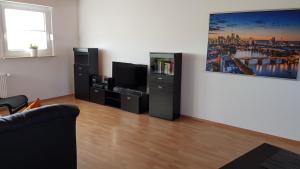 a living room with a couch and a flat screen tv at Ferienwohnung Horvath in Kelkheim (Taunus) in Kelkheim