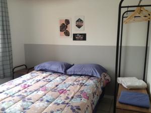 a bedroom with a bed and a wooden table at Apartamento Vila do Sol in Blumenau