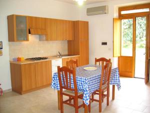 a kitchen with a table and chairs and a kitchen with a sink at Agriturismo Torre Del Golfo in Cropani