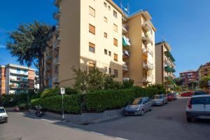 a tall building with cars parked in a parking lot at Vhome in Sorrento