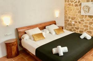 a bedroom with a bed with towels on it at Villa Sa Paissa in Cala Vadella