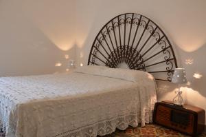 En eller flere senger på et rom på Villa Alchea Locazione Turistica