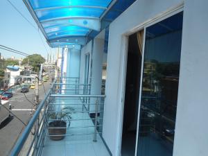 a balcony of a building with a blue ceiling at Hotel Palmeras De Mariana in Bucaramanga