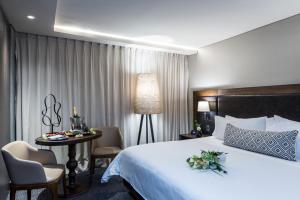 Ένα ή περισσότερα κρεβάτια σε δωμάτιο στο Movich Hotel Las Lomas