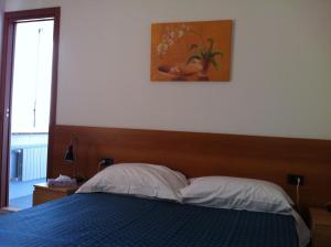 Postel nebo postele na pokoji v ubytování Hotel Pontenuovo