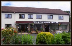 a large building with a sign on the front of it at Willowbank Hotel in Largs